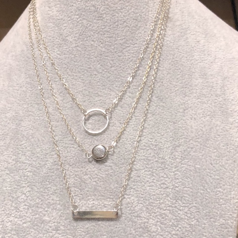 Silver necklace with three separate lengths and one clasp